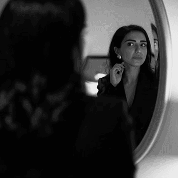 Member reflected in a round mirror